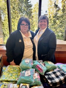 Terri Oster and Jeanine Spencer stand ready to pack up gift bags