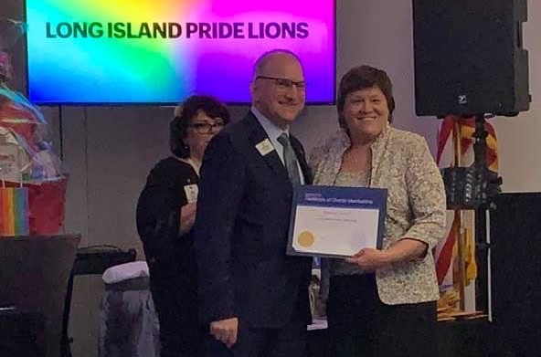 Jeanine Spencer receiving a certificate from Anthony Paradiso