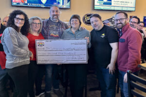 Jeanine Spencer accepting a donation of $1500 from the LI Pride Lions