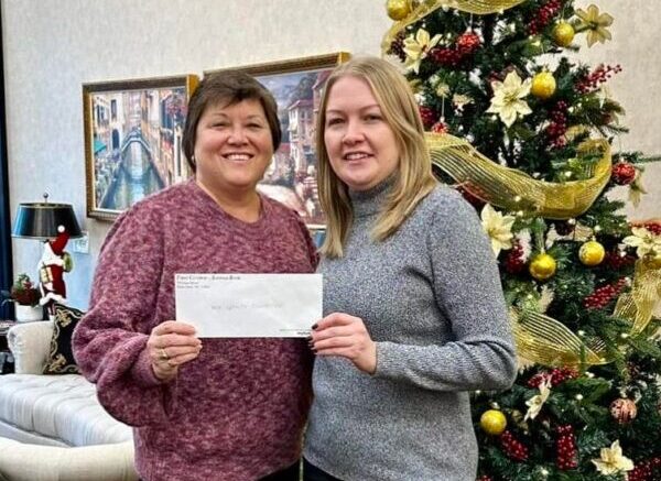 Jeanine Spencer accepting a donation check from First Central Savings Bank