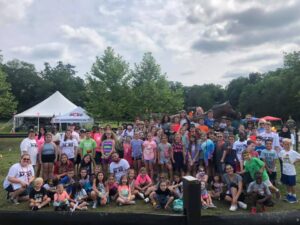 A crowd of happy campers poses at Saddle Rock Ranch Day Camp