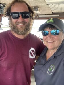 Jeanine with Captain Zack in the cabin of the Captain Eddie B III