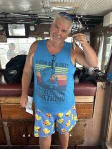 A patient angler with a much smaller fish