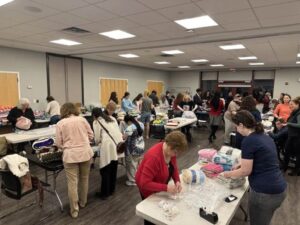 Volunteers packing up handmade blankets at a WeCare Blankets wrapping party
