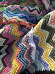 Beautiful hand-crocheted blankets in a rainbow of colors