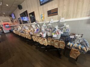 Raffle basket table at Lion's Den Bar and Grill fundraiser