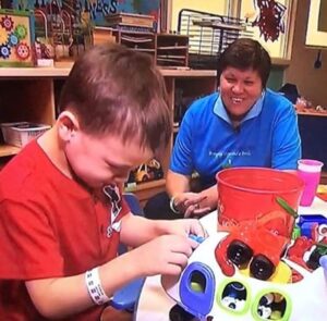 Jeanine Spencer playing with a child in the Stony Brook Children's Hospital playroom