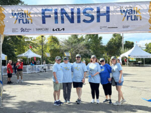 Team Spencer smiles triumphantly at the finish line