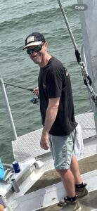 Sunglasses, hat, shorts and fishing rod - who needs anything else to be happy out on the water?