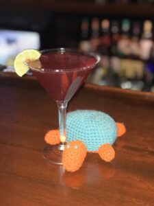 Crocheted turtle with a martini glass